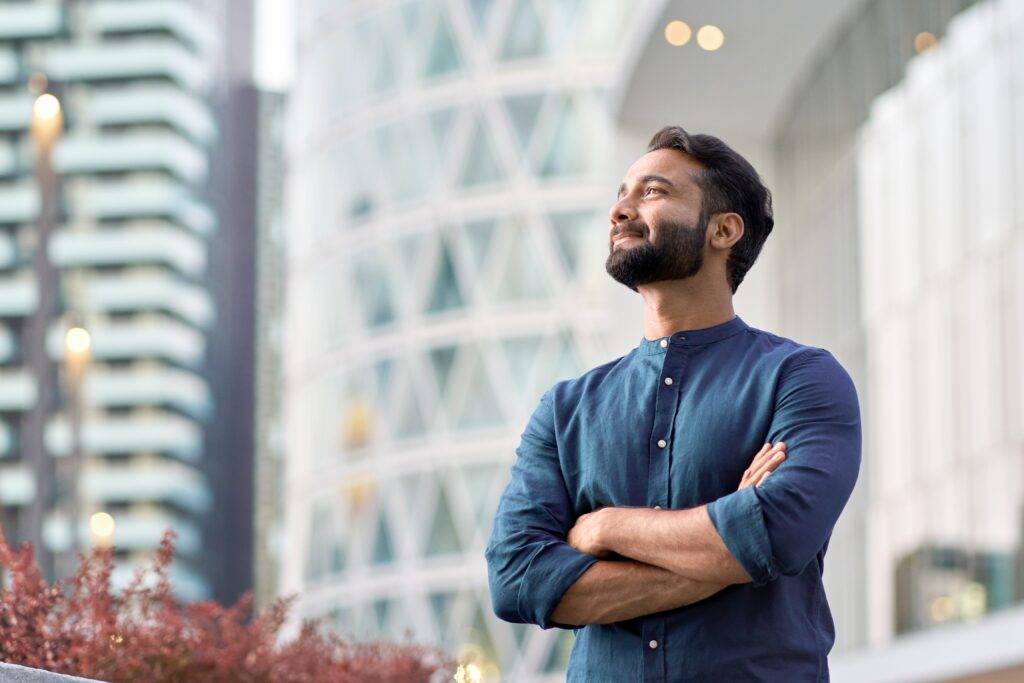 A businessman confidently looks out of the frame.