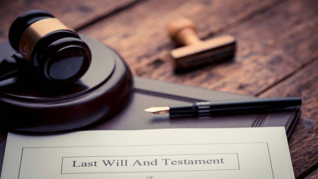 Gavel and pen with words last will and testament written on document